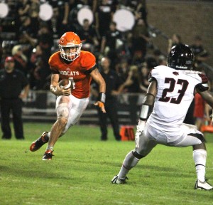 Orangefield quarterback Matthew Watkins looks to escape a Wildcat defender in the second-half of Friday's game. (Tommy Mann Jr. / The Orange Leader)